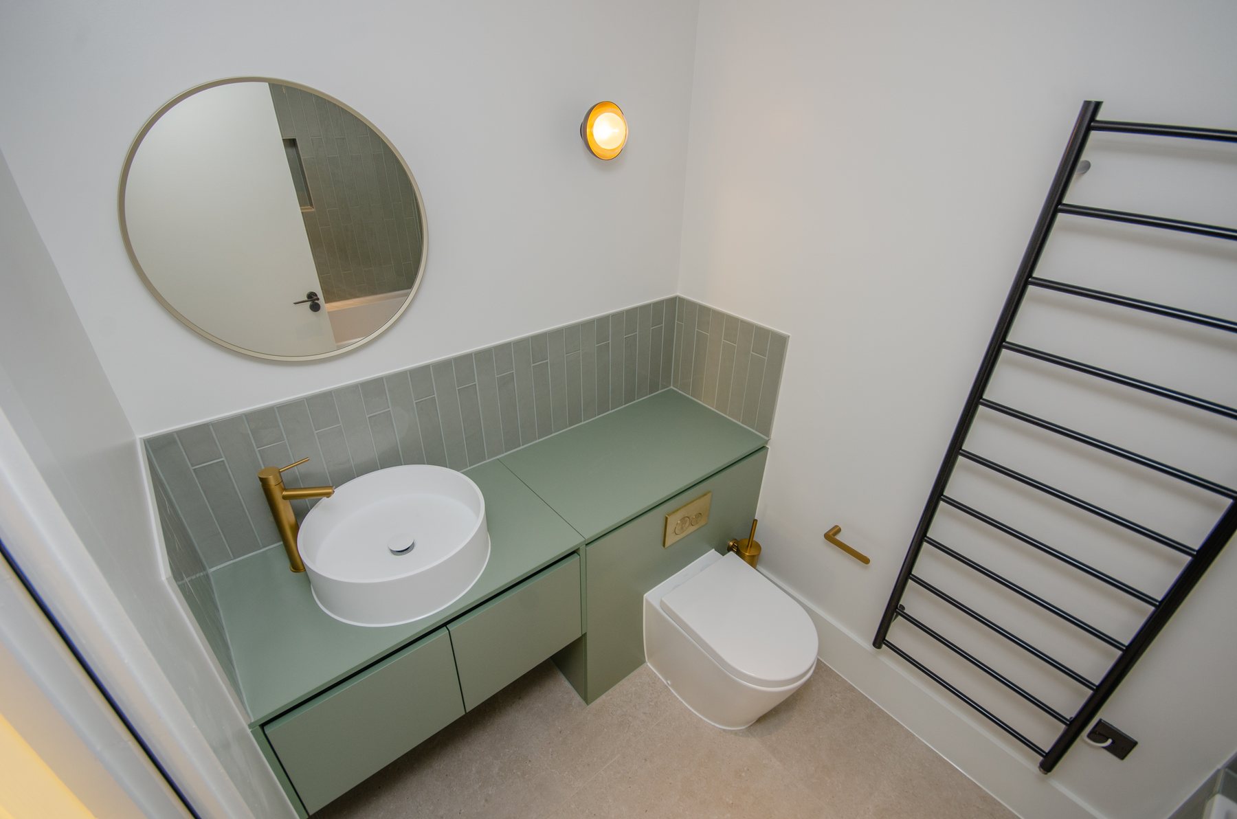 A vanity unit with basin alongside a WC compartment